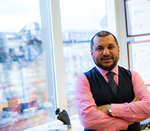 Dr. Sadiq smiles in his office