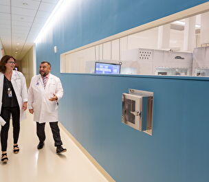 Dr. Sadiq and Dr. Harris walk down a hallway